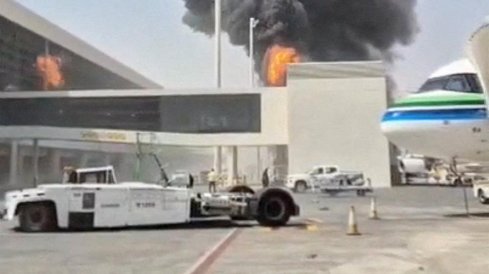 Smoke and flames rise from King Khalid Airport after a Houthi strike in Riyadh