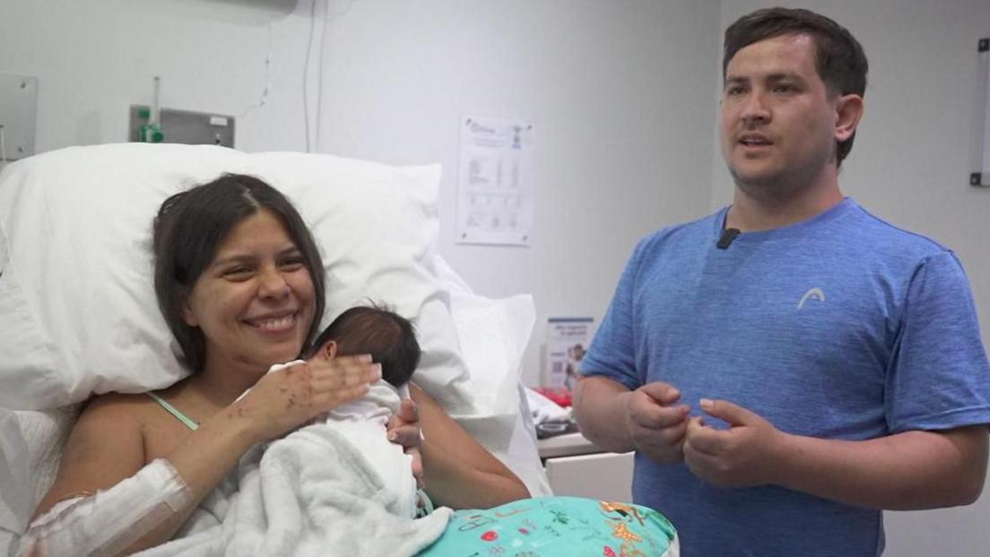 Dayana Patino holding her son Juan David in a hospital