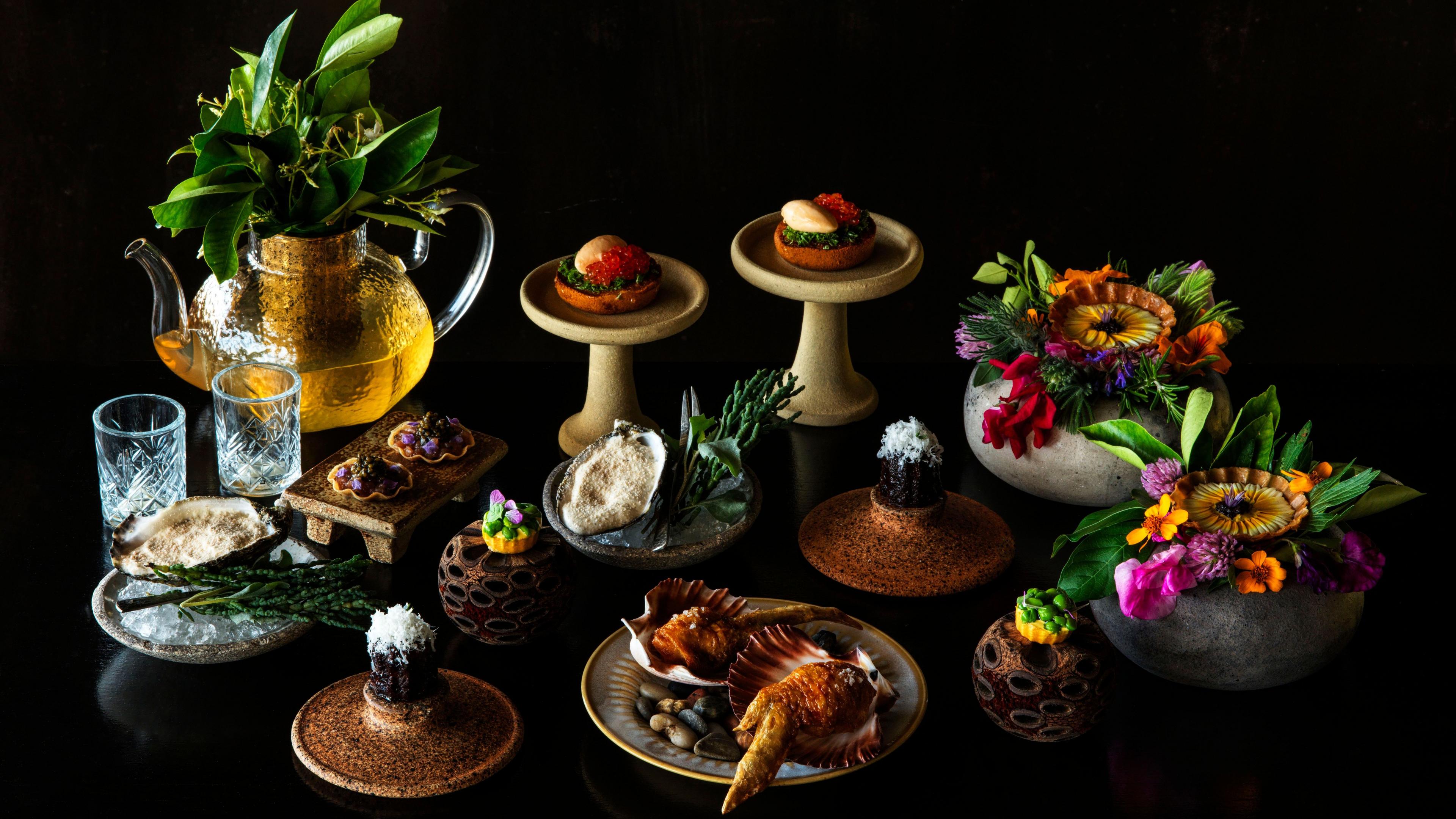 A selection of sophisticated dishes and bowls of flowers