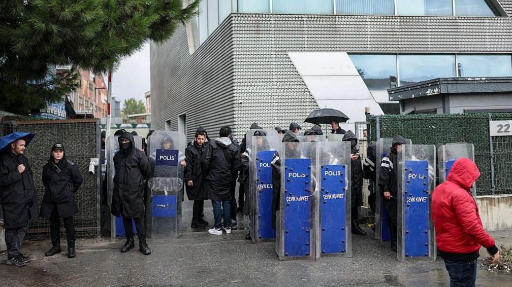 Police in riot gear outside the Halk TV building in Istanbul