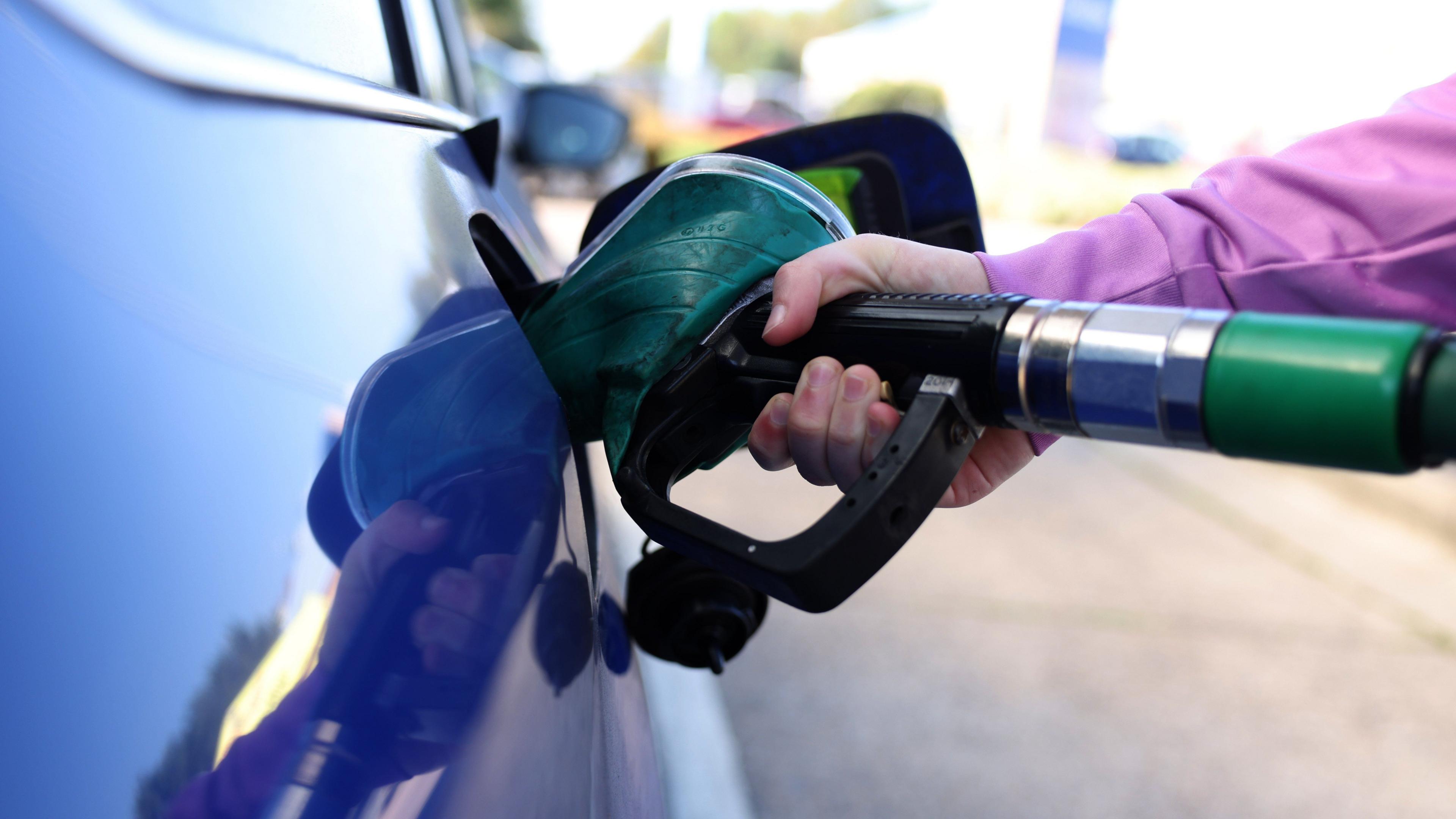 Fuel being pumped into a car
