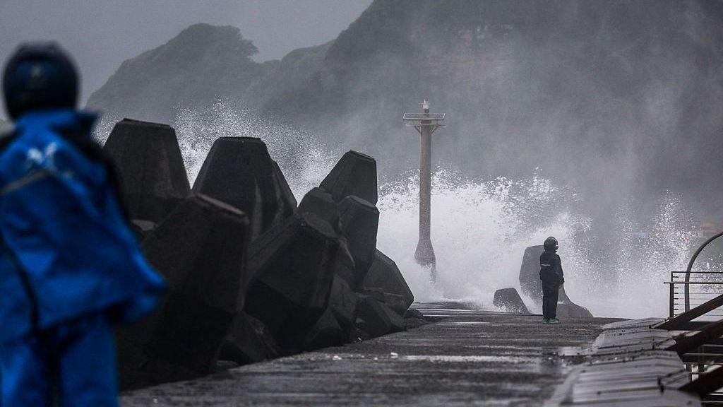 Large waves crash against a coastal breakwater during stormy weather in Taiwan.