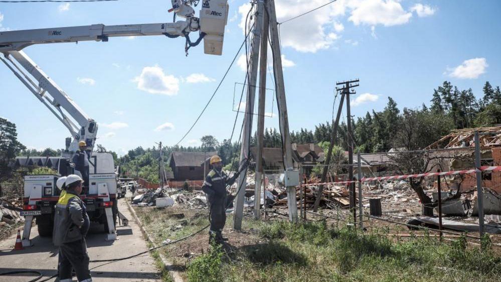 Employees of DTEK energy company in Ukraine work to restore power supply following a missile strike in July